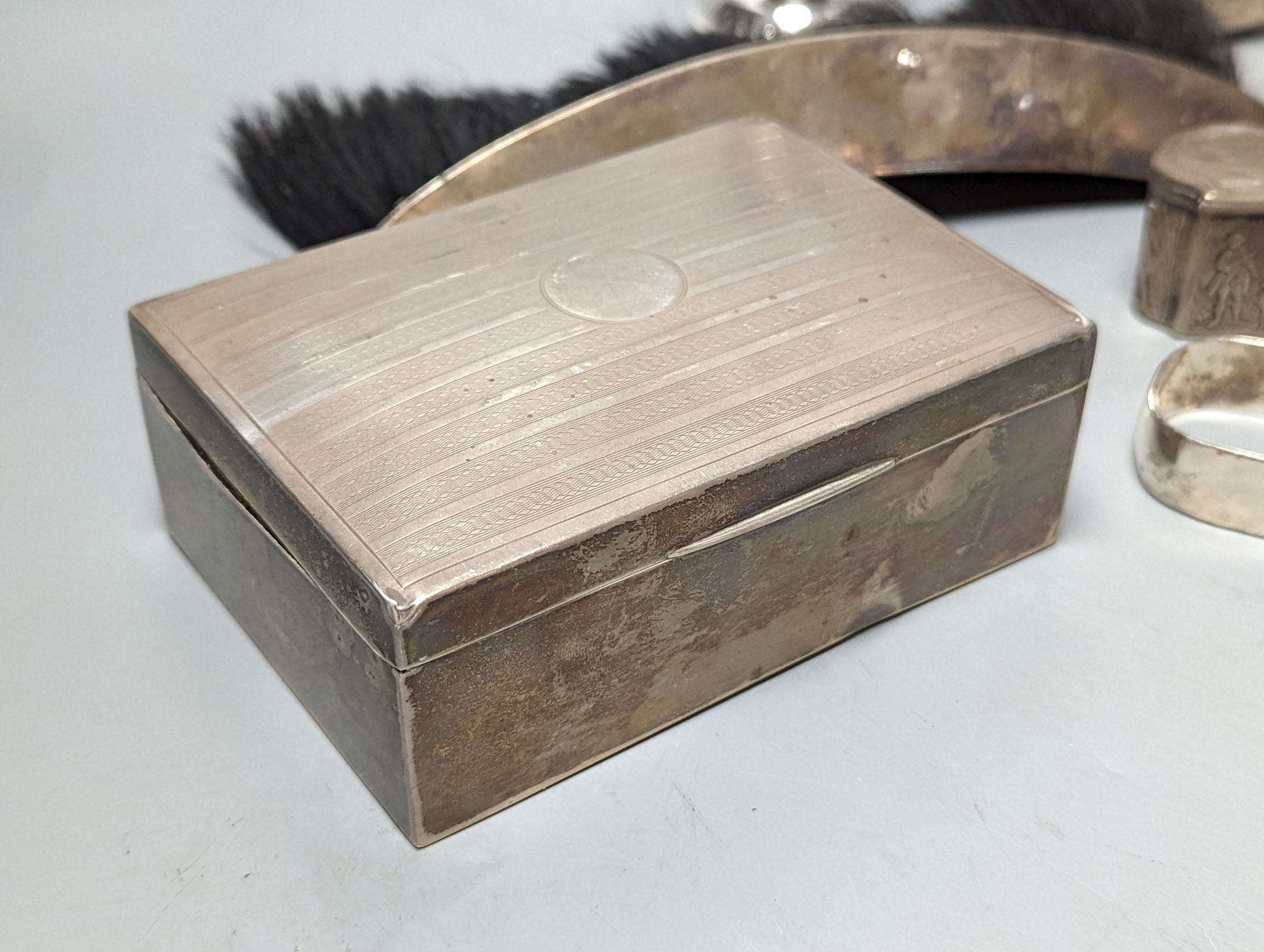 A group of assorted silver items including George V silver mounted hip flask(bruise), a pair of silver sauceboats(a.f.) one other sauceboat, sterling box, two silver cream jugs, cigarette box, salt, sugar tongs, brush an